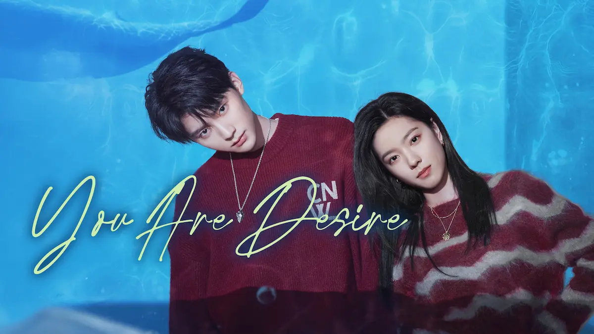 A young man in a red sweater and a young woman in a striped sweater leaning together against a light blue water ripple background