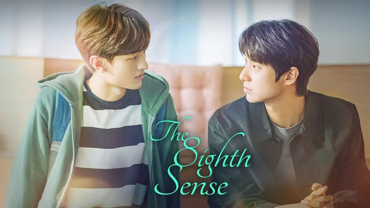 Two young men looking at each other inside a room with soft ambient lighting